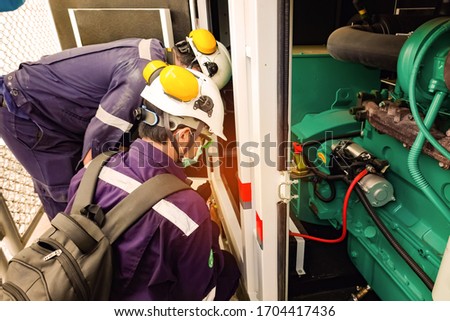 Selective focus of the technician is checking the condition of the battery by battery tester.