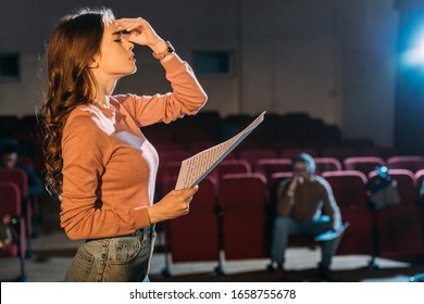 selective focus of theater director and attractive actress with screenplay on stage - Shutterstock ID 1658755678