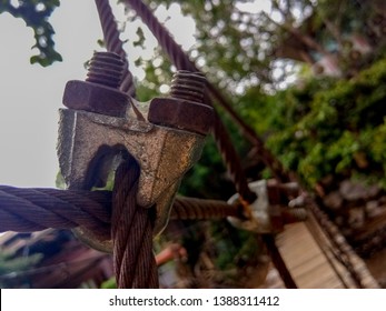 Selective Focus Thick Steel Rope Close Up. Bridge Fence Element. The Surface Of The Steel Cable Is Covered With Rust