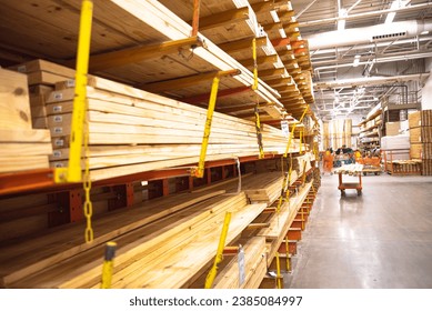 Selective focus timber shelves aisle with lumber cart, home improvement hardware store, chain link preventing warehouse rack collapse, building material framing, house, sheds construction. Industrial
