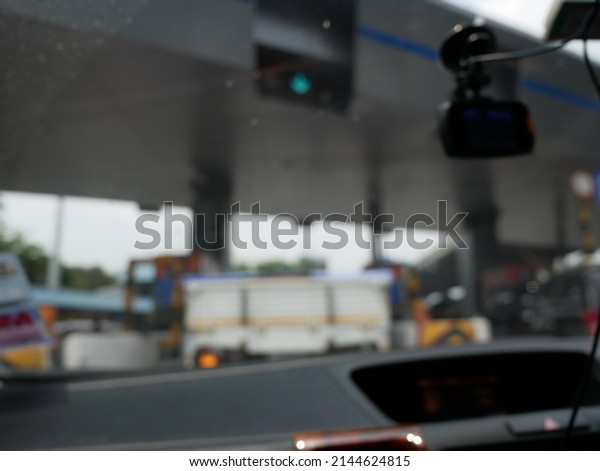 Selective focus to  a toll road toll gate motorway\
entrance. pay express\
way.