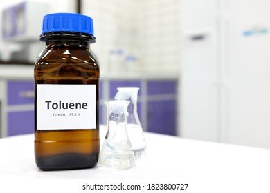 Selective focus of toluene liquid chemical compound in dark glass bottle inside a chemistry laboratory with copy space. Aromatic hydrocarbon used in petrochemical industry.