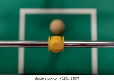 Selective Focus Top View On A Foosball Goalie Blocking The Ball Insider The Box.