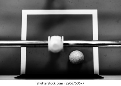 Selective Focus Top View On A Foosball Goalie Blocking The Ball Insider The Box.