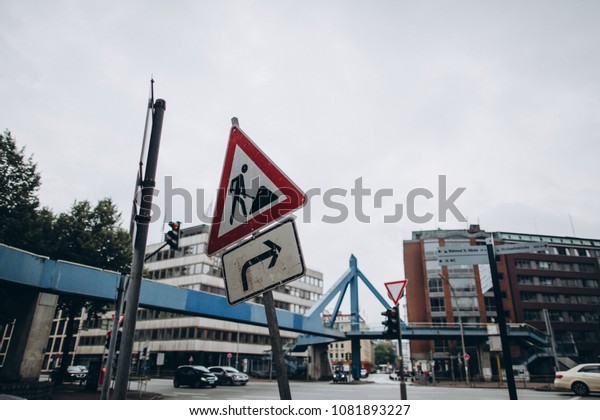 selective focus of traffic city signs and\
buildings on background, hamburg,\
germany