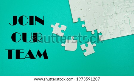 Selective focus of a uncomplete puzzle that has two piece missing. A quote of a text Join Our Team