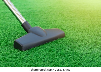 Selective Focus Of A Vacuum Cleaner On A Sheet Of Artificial Turf. Lawn Care And Maintenance. Easy To Clean Artificial Greenery Roll