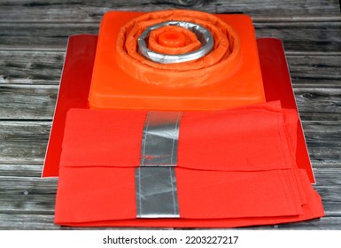 Selective Focus Of Vehicles Safety Measures Of Warning Foldaway Reflective Road Hazard Warning Car Traffic Cone, Safety Vest With Reflective Stripes And Phosphorescent Reflective Stickers