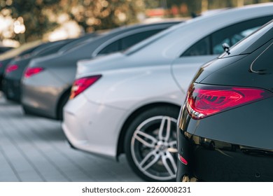 A selective focus view of different cars parked in a row