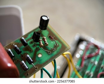 Selective focus view of electronic circuit with cable and resistor on blurred background. Macro photography.