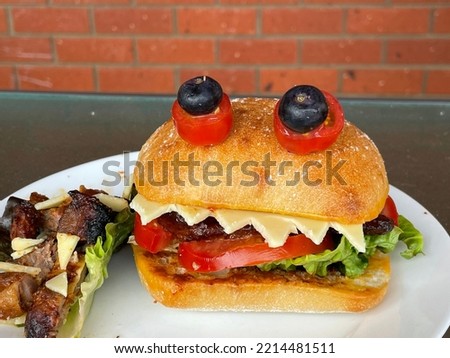 Selective focus view Halloween Monster Burgers or sandwiches, egg mayo, on white ceramic plate. Halloween food concept, celebration party, Vegan Food. Kid party food