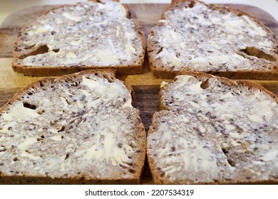 Selective Focus View At Slices Of Fresh Baked Crusty Bread With Butter