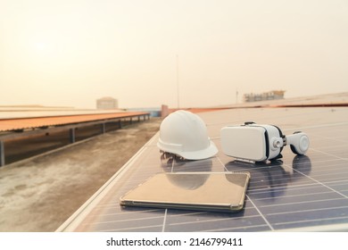 Selective focus. VR headset and tablet on solar panel. Electrical engineering. Technology solar cell energy renewable concept.