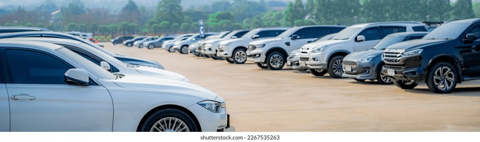 Selective focus white car parked at parking lot. Used car for sale and rental service. Car insurance background. Automobile parking area. Car dealership and dealer agent concept. Automotive industry. - Shutterstock ID 2267535263