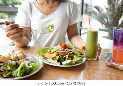 Selective Focus Of Woman With Broccoli And Salad Which She Make A Intermittent Fasting With A Healthy Food Of Salad And Detox Drink ,Healthy Lifestyle Concept.