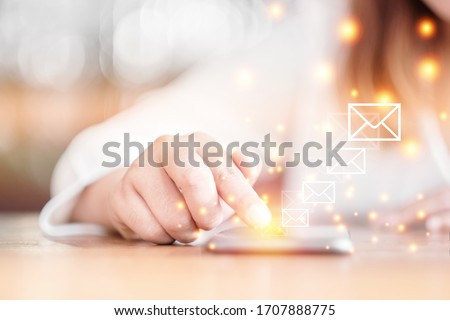 Selective focus woman hand with Messages icons on smartphone screen. Communication Email concept.