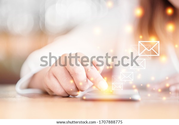 Selective focus woman hand\
with Messages icons on smartphone screen. Communication Email\
concept.