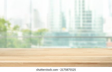 Selective focus.Top of wood  table with window glass and cityscape background.For montage product display - Shutterstock ID 2175875525