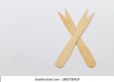 Selective Focus Of Wooden Cocktail Fork On White Background, Two Small Wood Spike Fork Toothpick, A New Alternative Cutlery That Can Decompose Naturally, Eco Friendly Products.