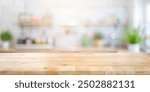 Selective focus.of Wooden table top on blur kitchen counter background. For montage product display or design key visual layout