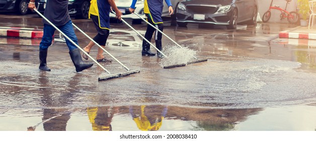 Selective focus to worker using wiper or squeegee to clean floor surface. Staff cleaning floor with wiper. The concept of cleaning service. - Powered by Shutterstock