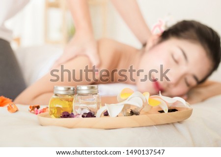 Selective focus Young asian woman enjoying relaxing back massage in spa. Body care, skin care, wellness, alternative medicine and relaxation Concept.