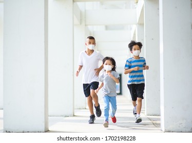 Selective focus at young boy running with friends wearing mask to protect virus and pollution.