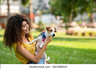 Selective Focus Of Young Woman On Grass With Dog In American Flag Bandana