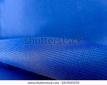selective focus of zigzag fabric fibers. rough surface of blue burlap material