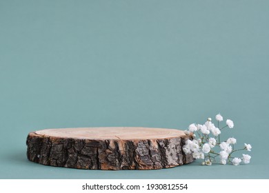 Selective focus.A minimalistic scene of a felled tree lies with flowers on a natural background. Catwalk for the presentation of products and cosmetics. Showcase with a stage for natural products.  - Shutterstock ID 1930812554