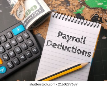 Selective focus.Calculator,pencil and banknotes with the word Payroll Deduction on world map background. - Shutterstock ID 2160297689