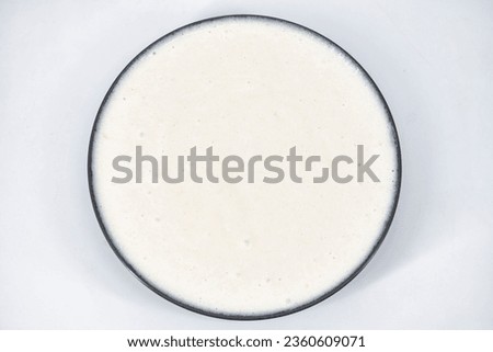 Selective focused image of fermented batter for idli and dosa in an isolated background. Idly and dosa batter in a bowl for fermentation, used to prepare the dosa and idli.
