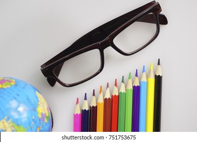 Selective focused mainly on colored pencils isolated on white background. Used with related objects (selective focused or out of focused) with educational concept purposes.