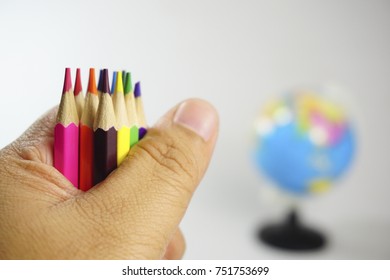Selective focused mainly on colored pencils isolated on white background. Used with related objects (selective focused or out of focused) with educational concept purposes.