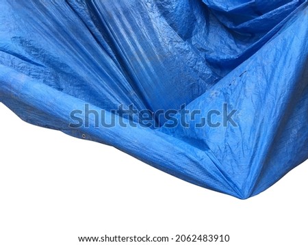 Selective focused photo of crunched blue tarpaulin isolated on white background with space for runaround or wraparound text 