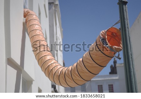Selective focused photo of temporary ventilation tunnel tube being used during construction work