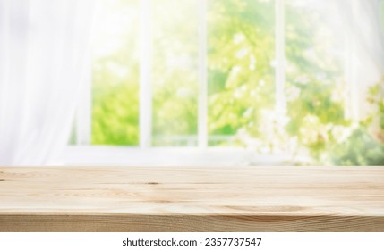 selective focus.Empty of wood table top on blur of curtain window and abstract green from garden with sunlight .For montage product display or design key visual layout - Powered by Shutterstock