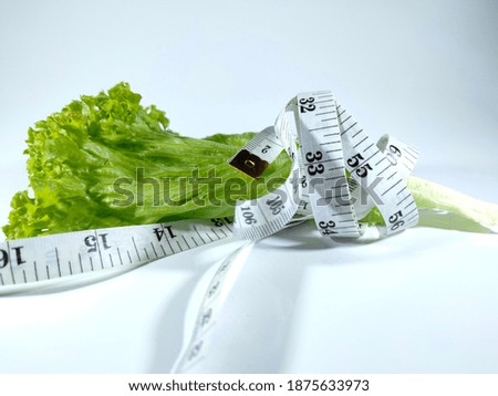 Similar – Image, Stock Photo Fresh leaf salad with a measuring tape on a board