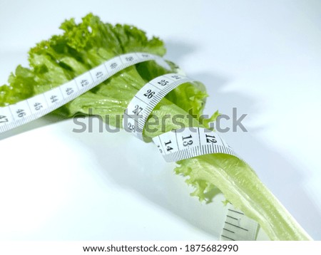 Similar – Image, Stock Photo Fresh leaf salad with a measuring tape on a board