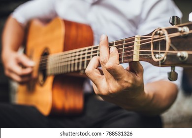 selective focus.hand musician playing acoustic guitar.concept for live music background,Music festival.Instrument on stage - Shutterstock ID 788531326