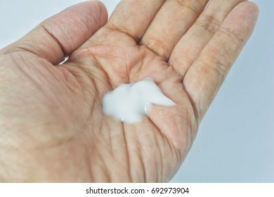 Selective focusing body lotion on asian woman hand. - Shutterstock ID 692973904