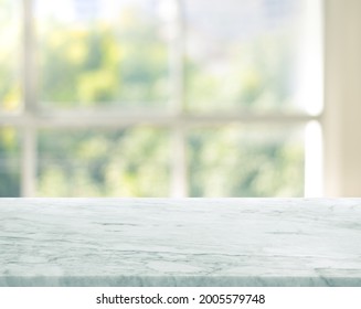 Selective focus.Marble table top on blur window glass background.For montage product display or design key visual layout. - Shutterstock ID 2005579748