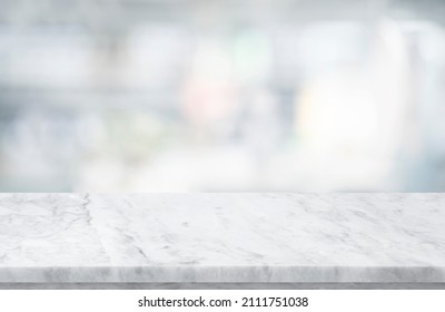 Selective focus.Marble table top on blur abstract window glass background.For montage product display  - Shutterstock ID 2111751038