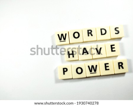 Selective focus.Scrabble letters with text WORDS HAVE POWER on white background.