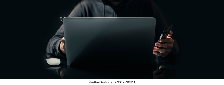 Selective Focus,Smartphone On Hand Businessman Is Working On Laptop. Stock Business Or Work From Home Concept. Dark Tone