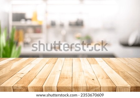 Selective focus.Wood table top on blur kitchen counter background.For montage product display or design key visual