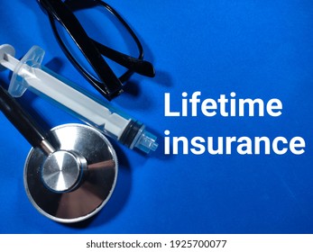 Selective Focus.Word Lifetime Insurance With Stethoscope,syringe And Glasses On Blue Background.Medical Concept.