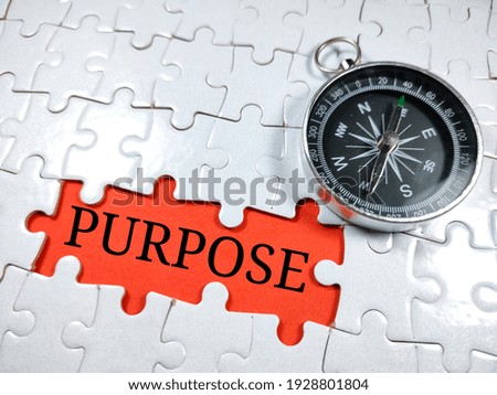 Selective focus.Word PURPOSE with compass on jigsaw puzzle and red background.Business concept. Stockfoto © 