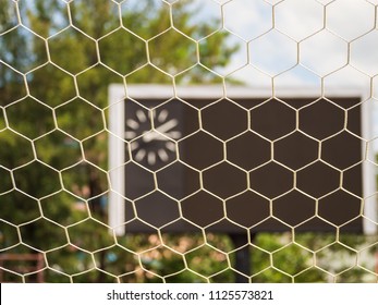 Selective Goal Net With Blurry Blank Score Board And Clock At Football Stadium.Outdoor Sport.