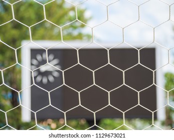 Selective Goal Net With Blurry Blank Score Board And Clock At Football Stadium. Outdoor Sport.